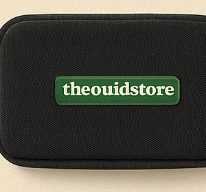 The Ouid Store black zip stash pouch with green wordmark badge